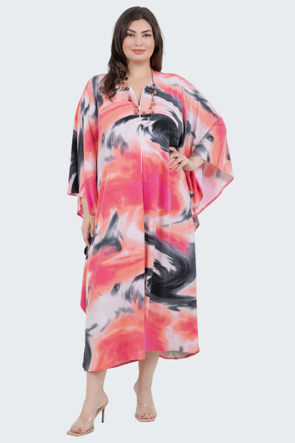 Woman wearing a colorful dress with abstract patterns on a white background