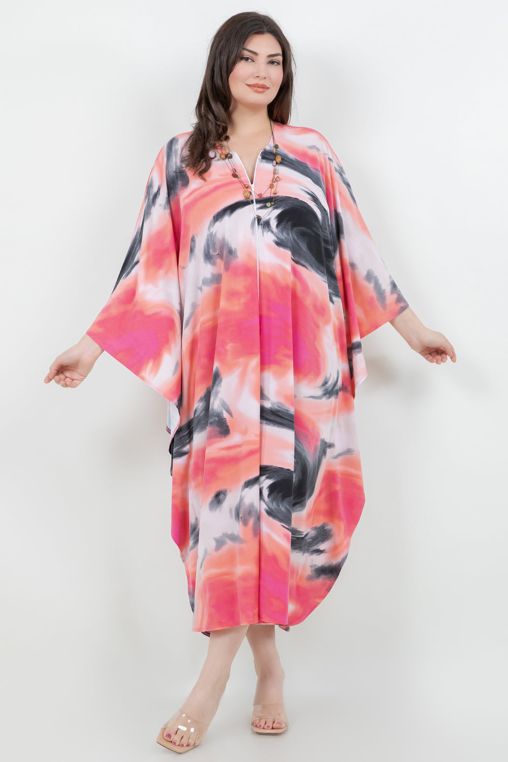 Woman wearing a colorful kimono-style dress on a white background