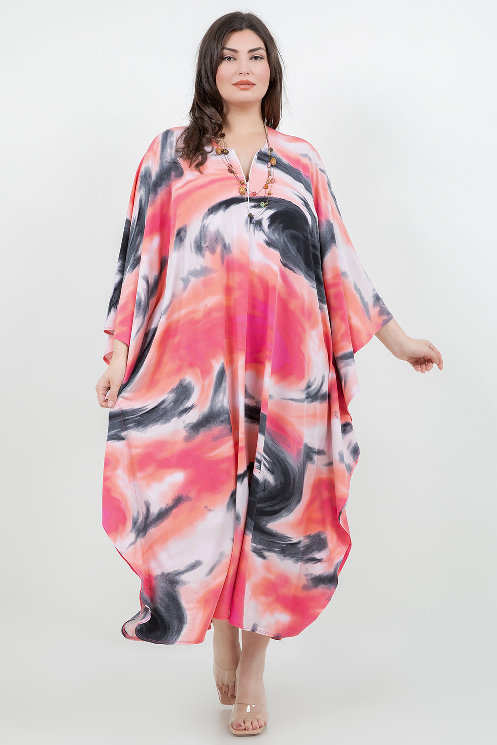 Woman wearing a colorful dress with abstract patterns on a white background