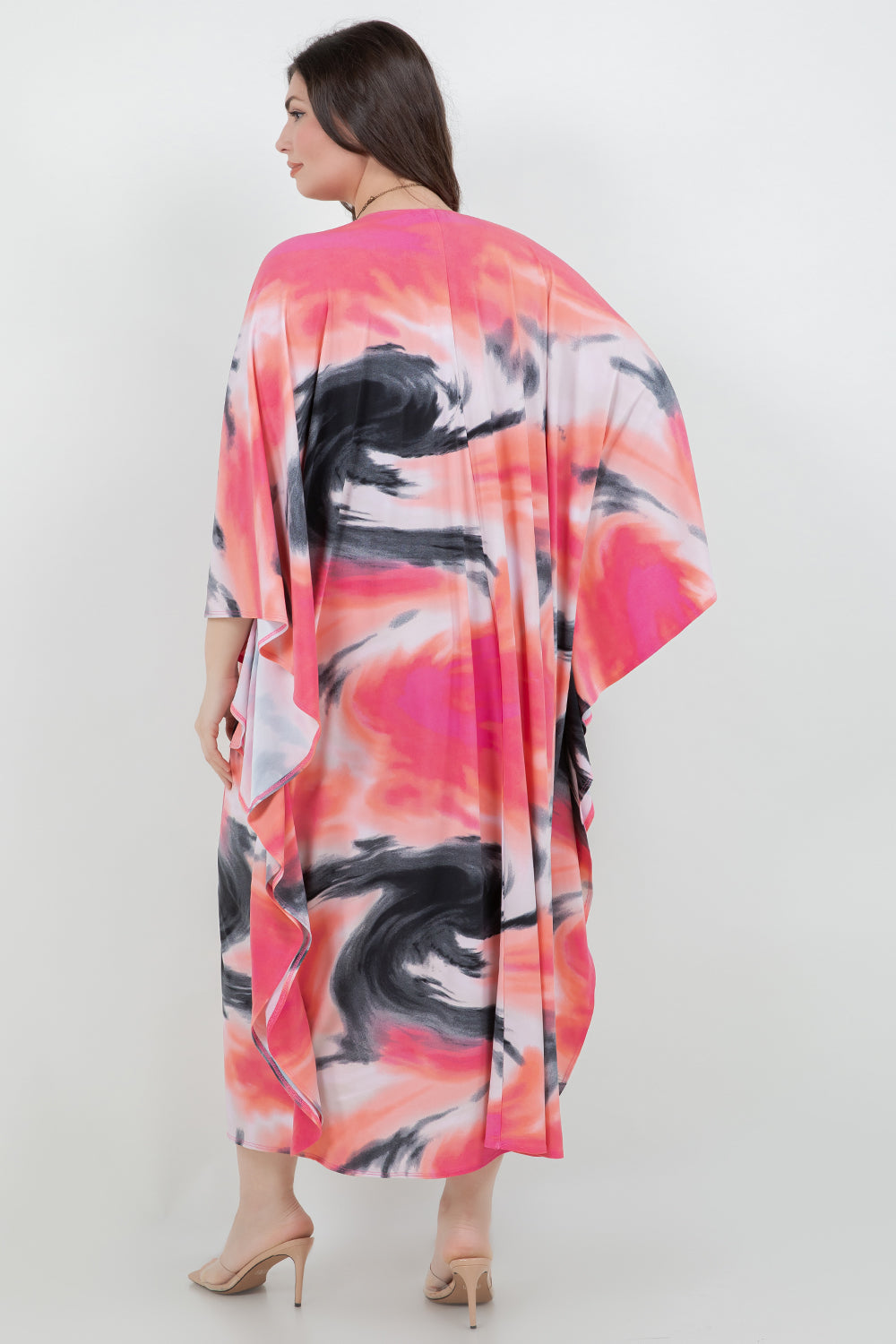 Woman wearing a colorful kimono-style garment on a white background