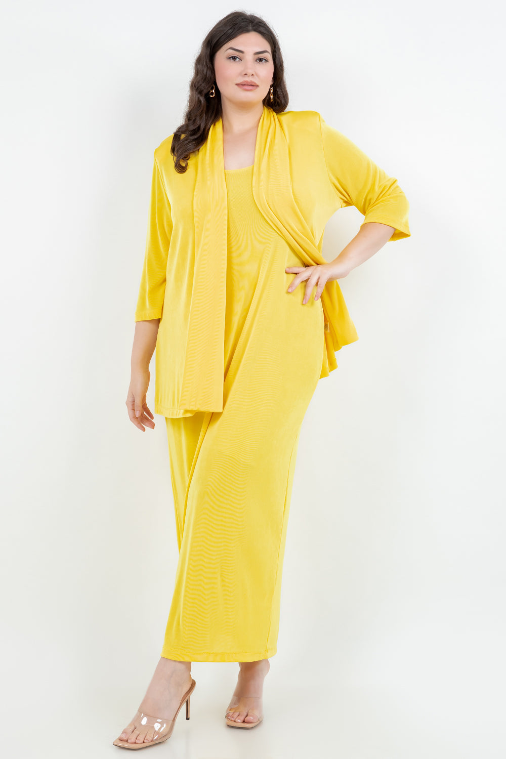 Woman wearing a yellow outfit with a matching jacket on a white background