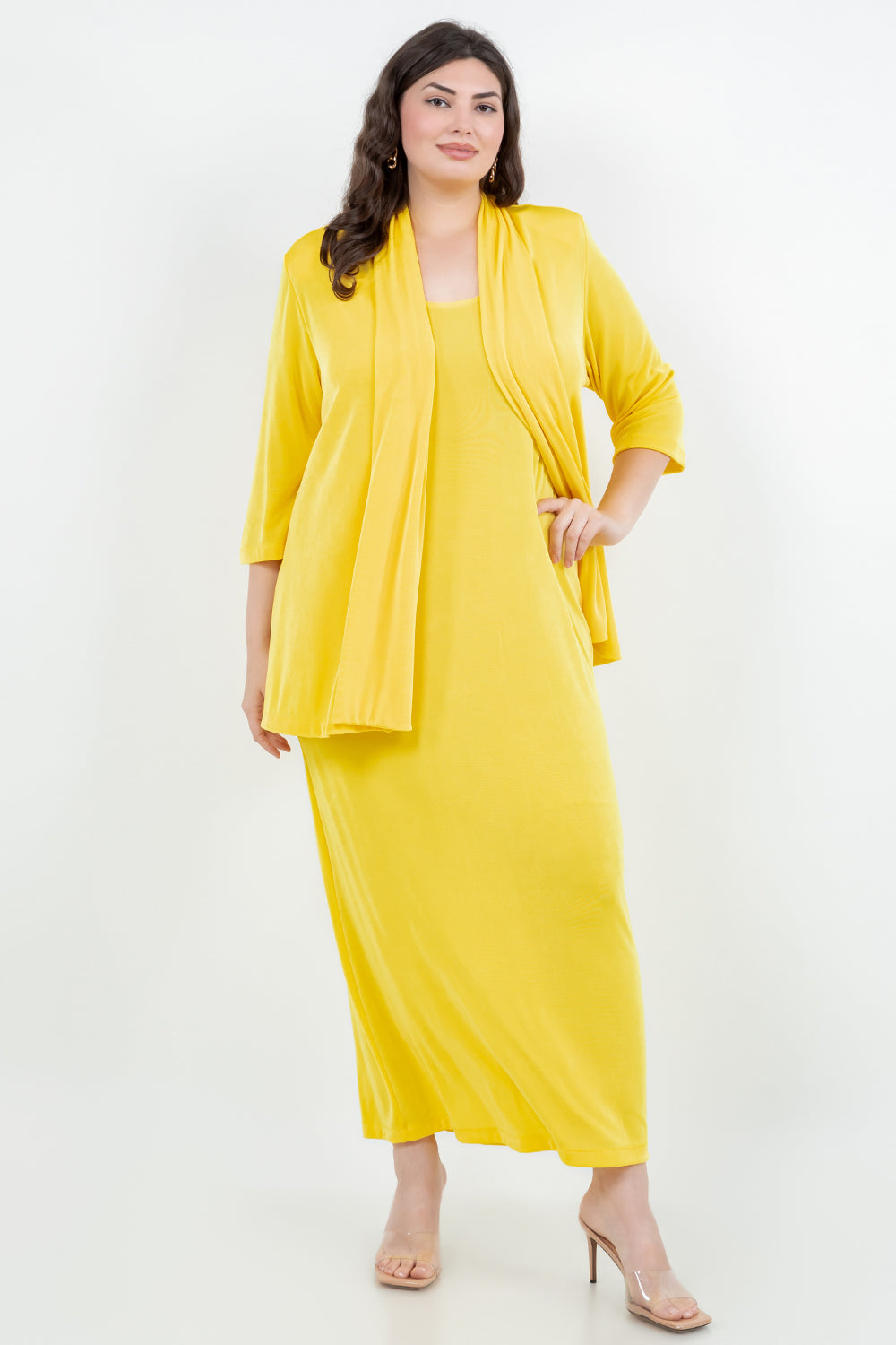 Woman wearing a yellow outfit with a matching jacket on a white background