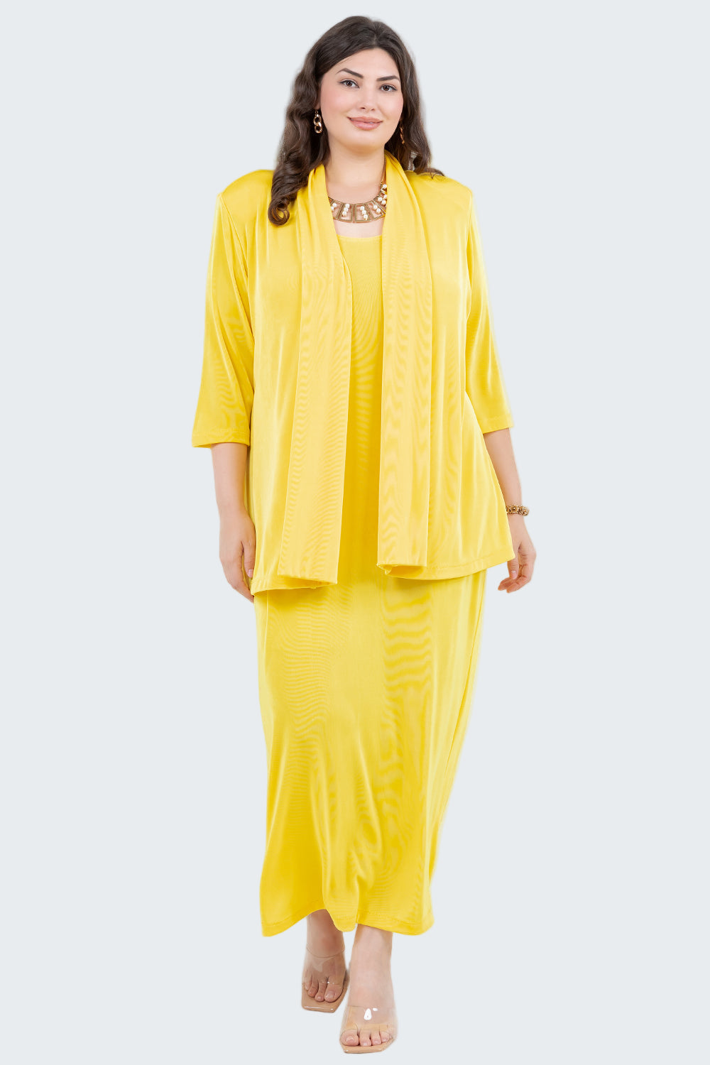 Woman wearing a yellow outfit with a matching jacket on a white background
