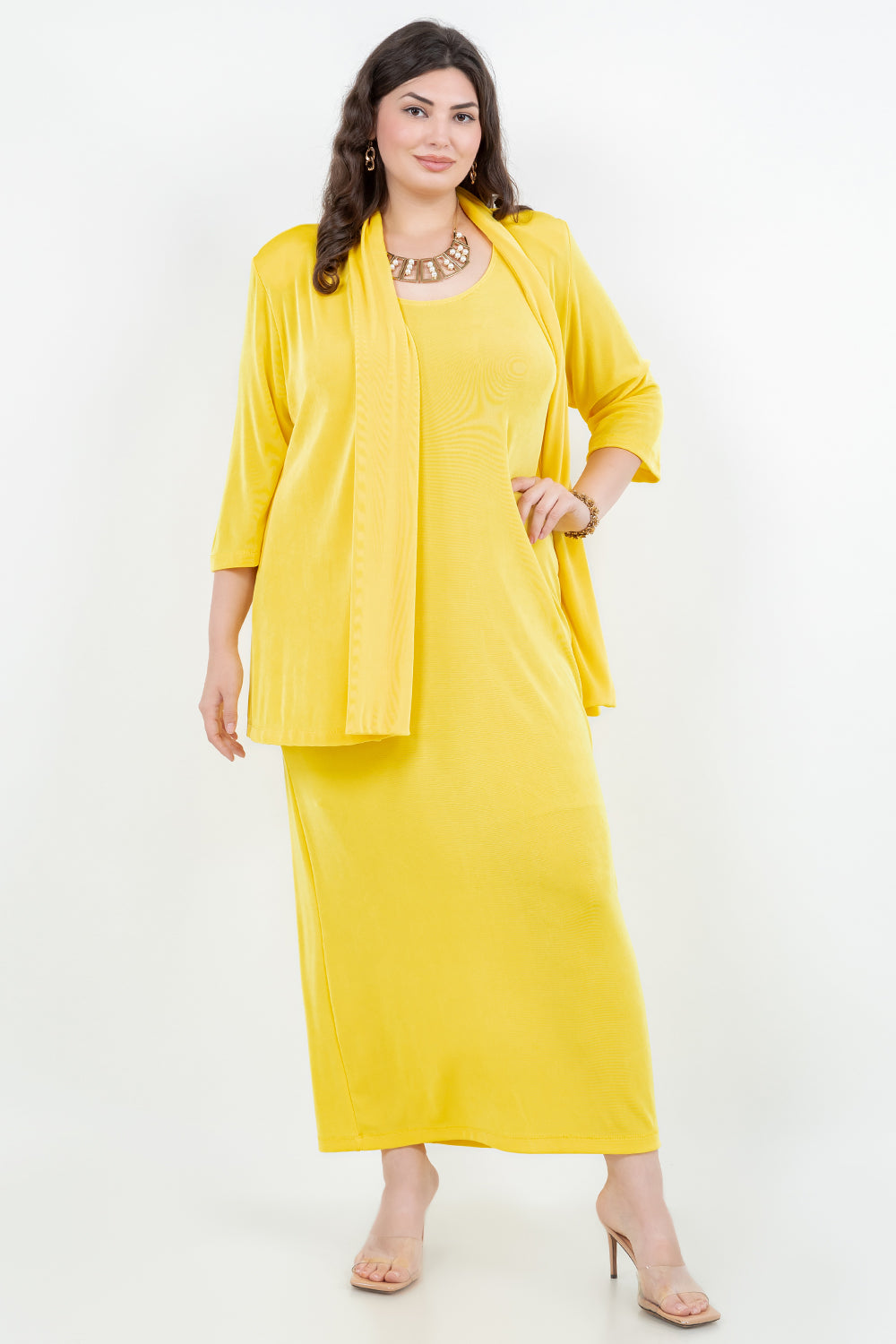 Woman wearing a yellow outfit with a matching jacket on a white background
