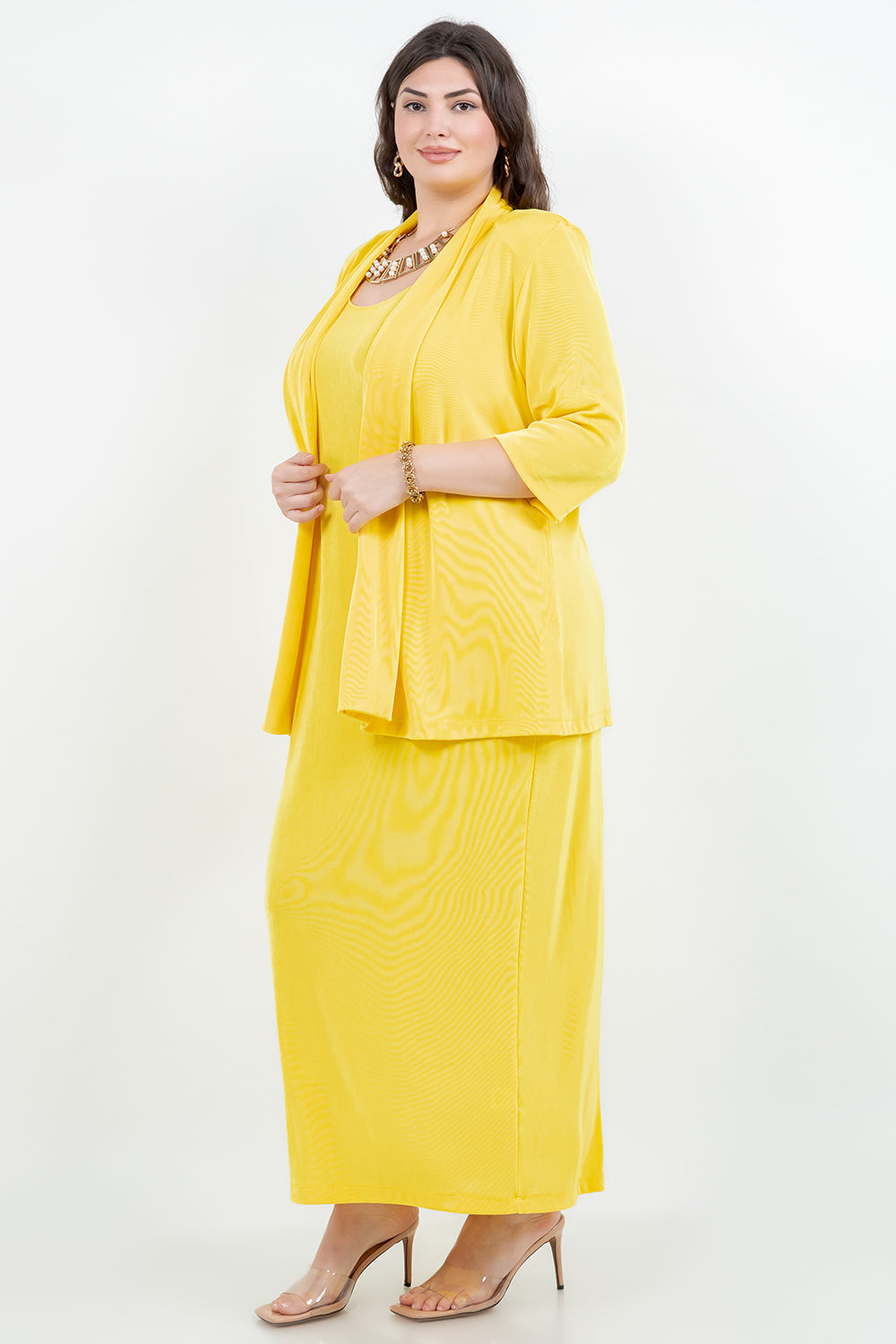 Woman wearing a yellow outfit with a matching jacket on a white background