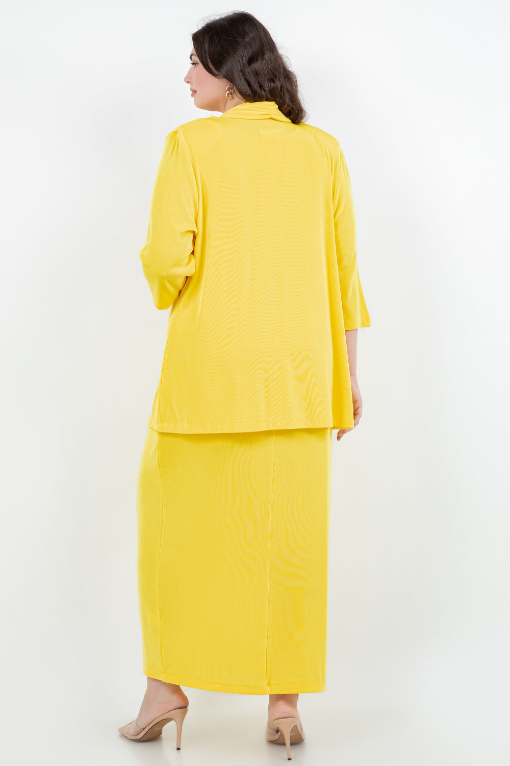 Woman wearing a yellow outfit on a white background