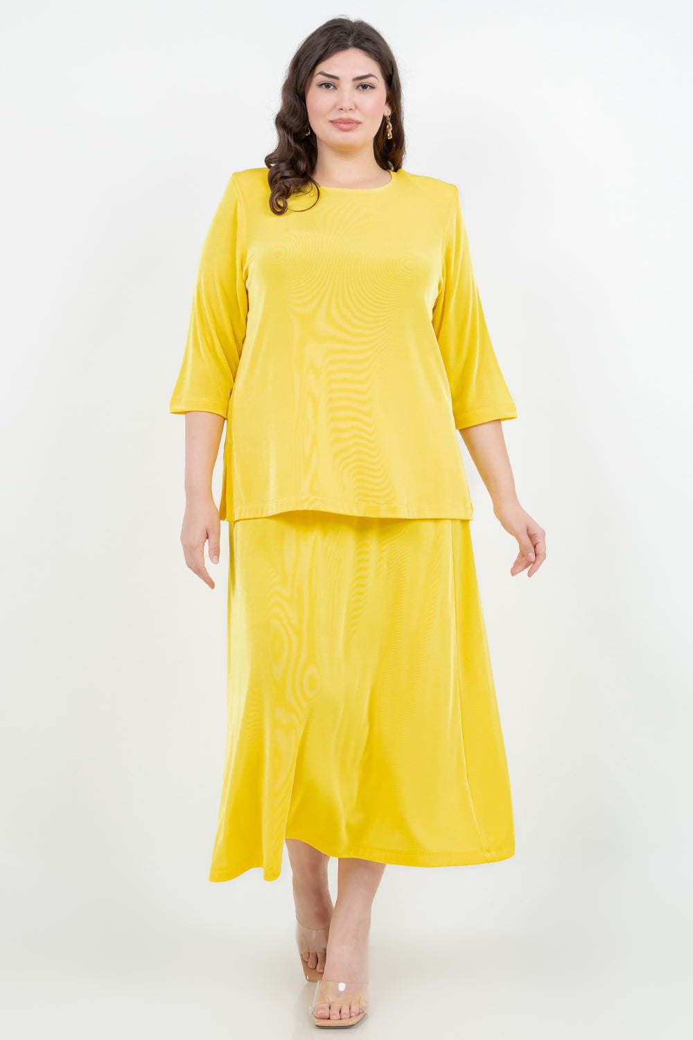 Woman wearing a yellow outfit on a white background