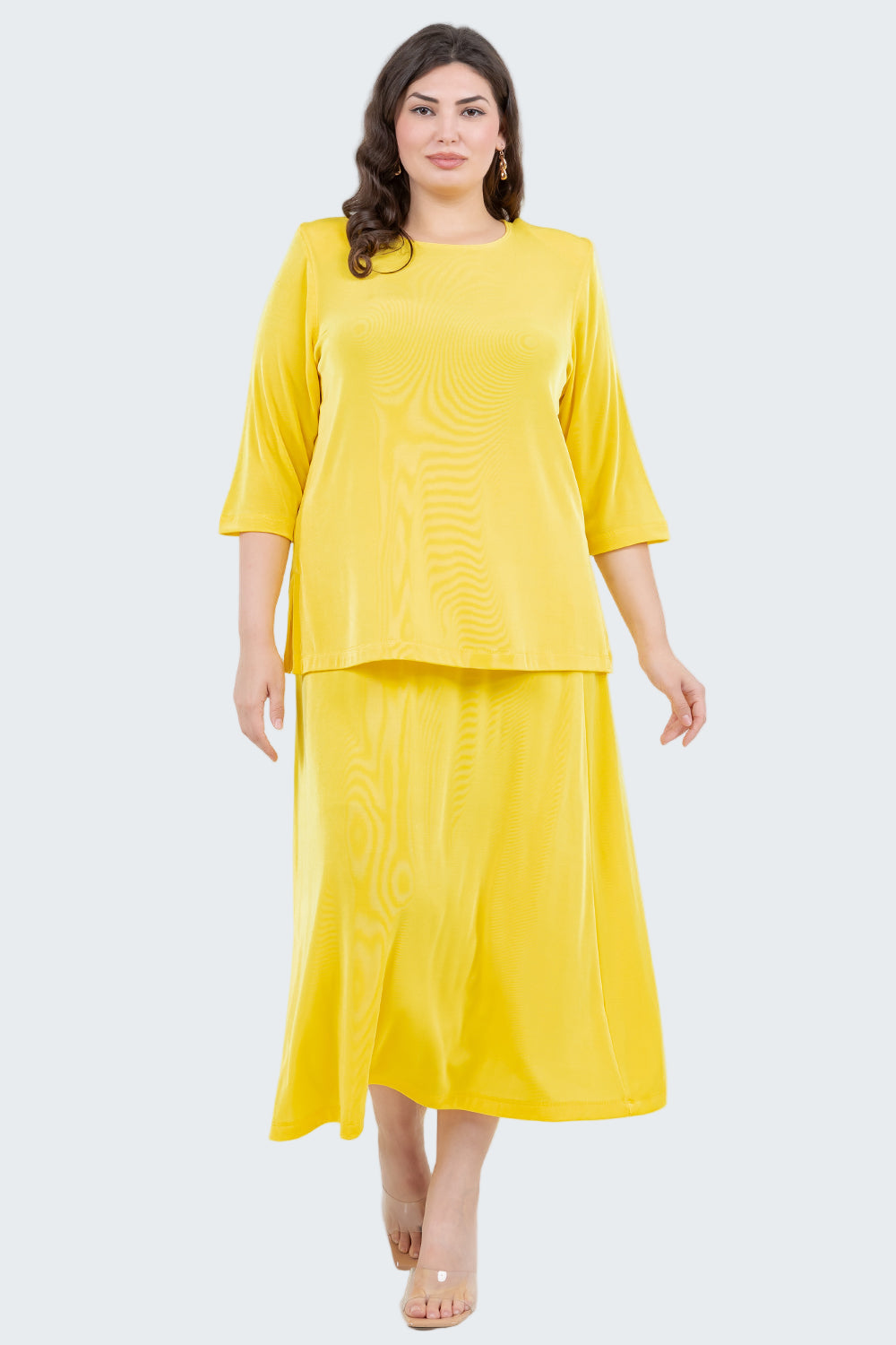 Woman wearing a yellow outfit on a white background