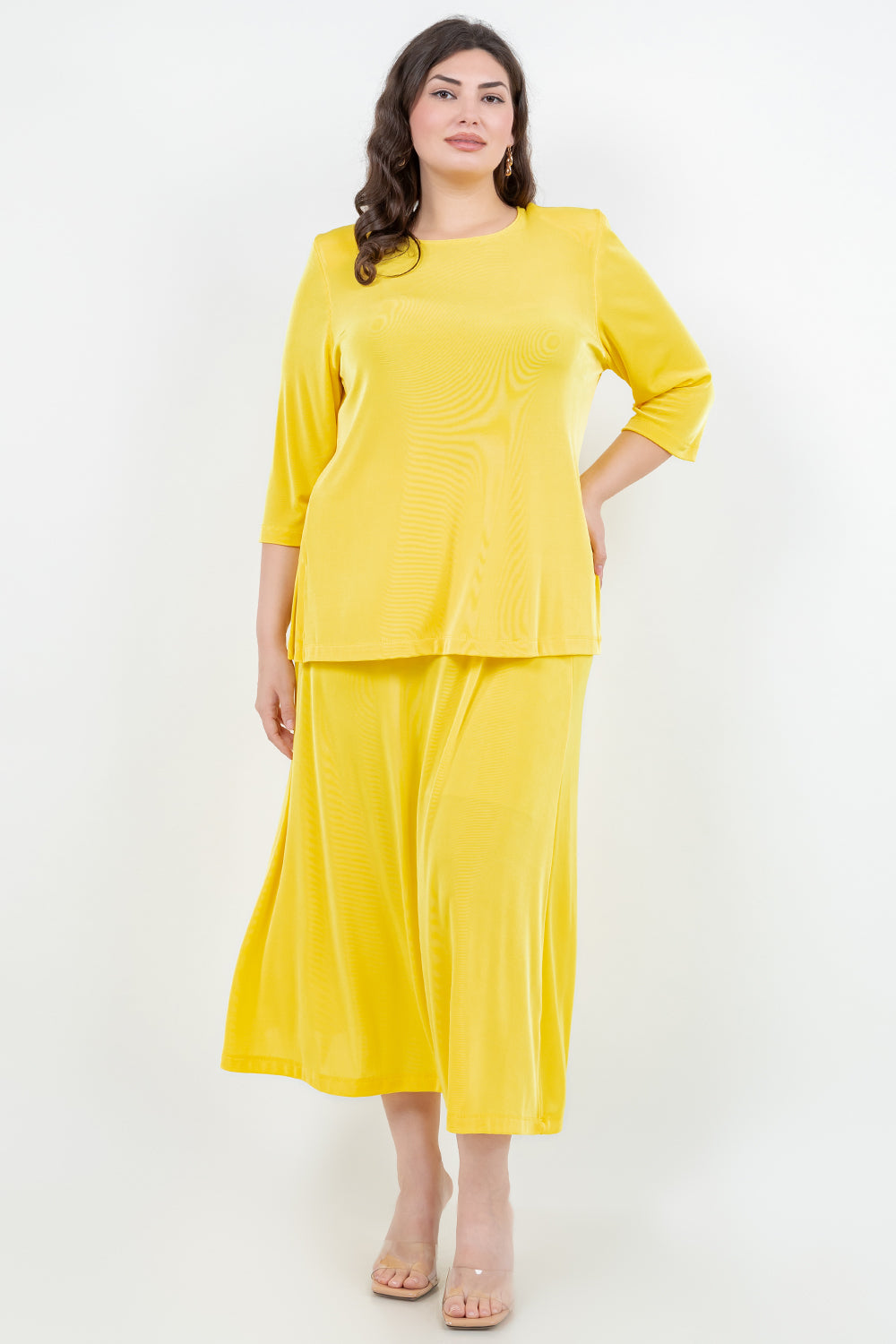Woman wearing a yellow outfit on a white background
