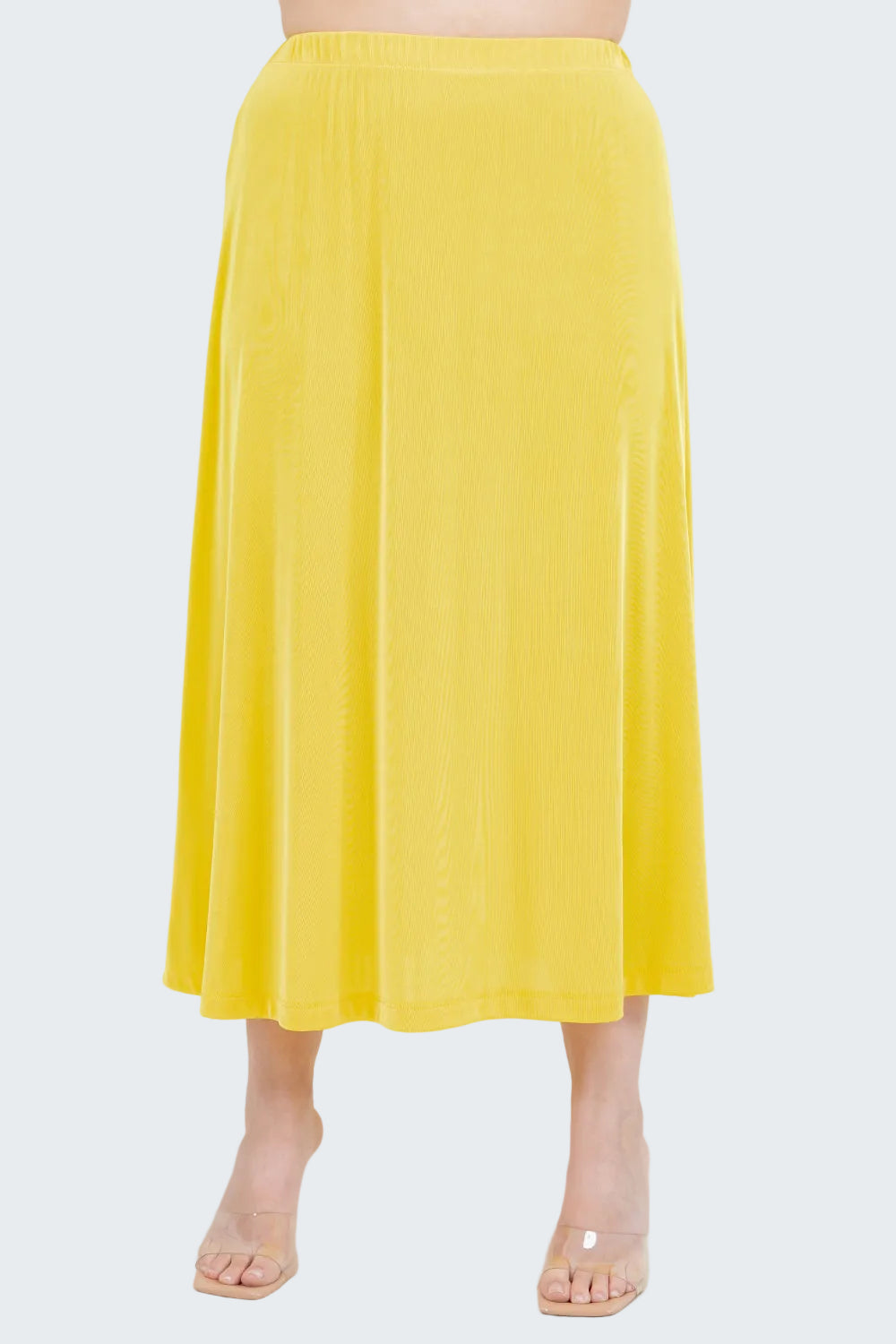 Yellow skirt worn by a person on a white background