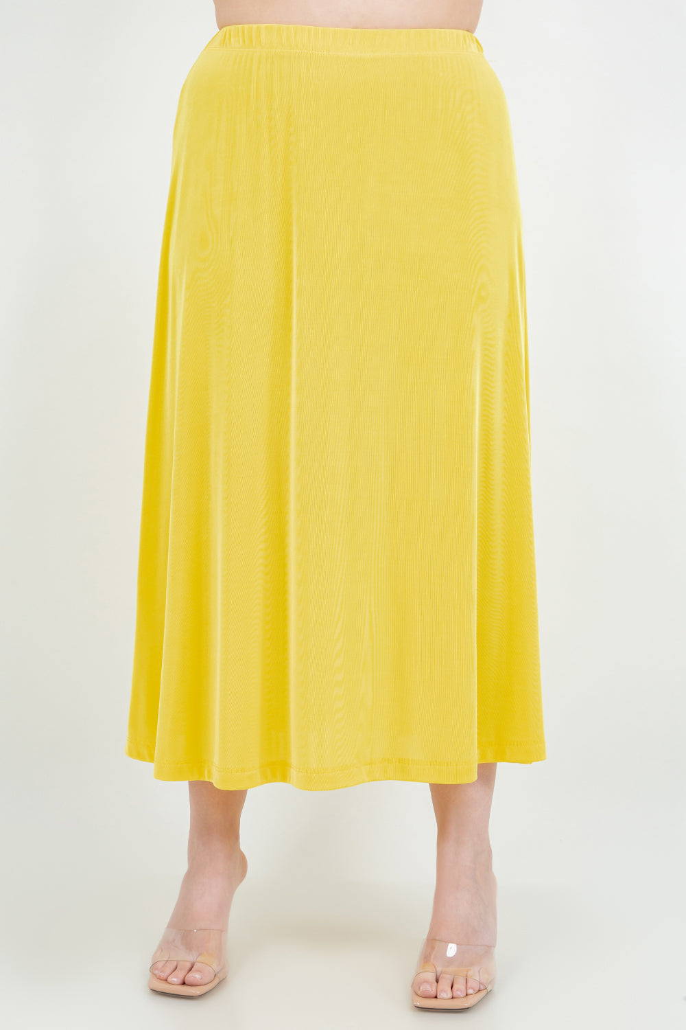 Yellow skirt worn by a person on a white background