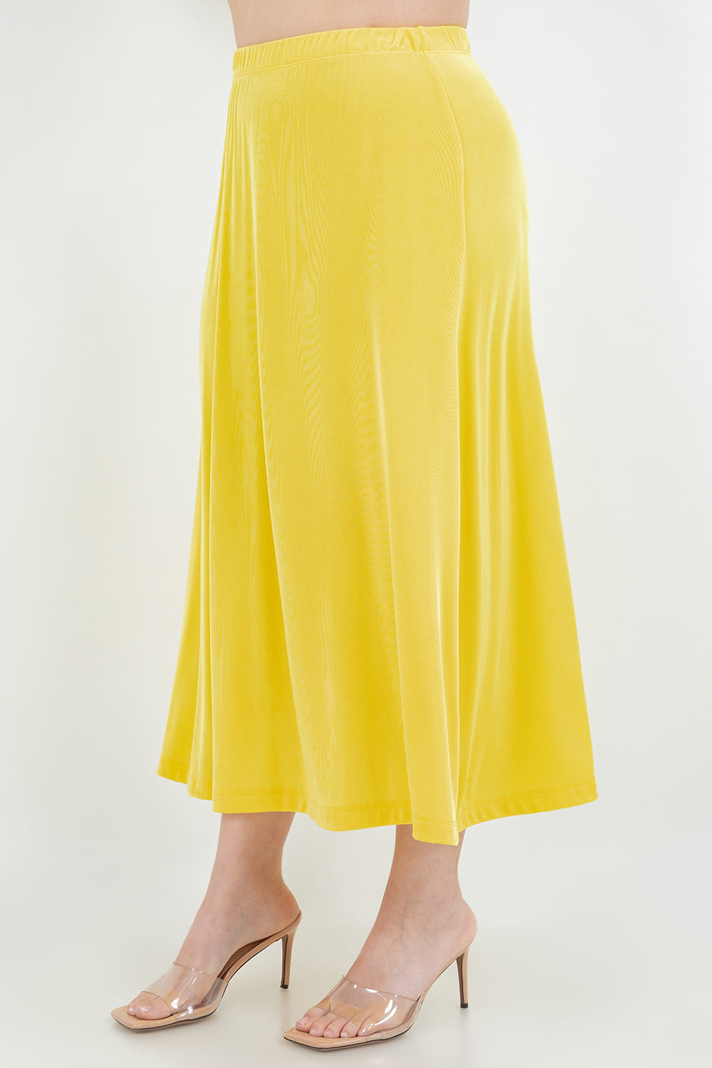 Yellow skirt worn by a person on a white background
