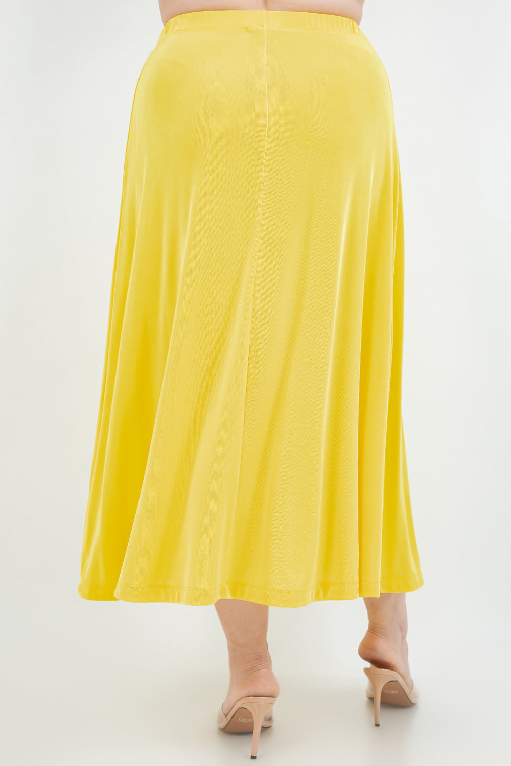 Yellow skirt worn by a person on a white background