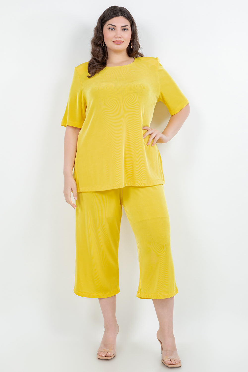 Woman wearing a yellow outfit on a white background