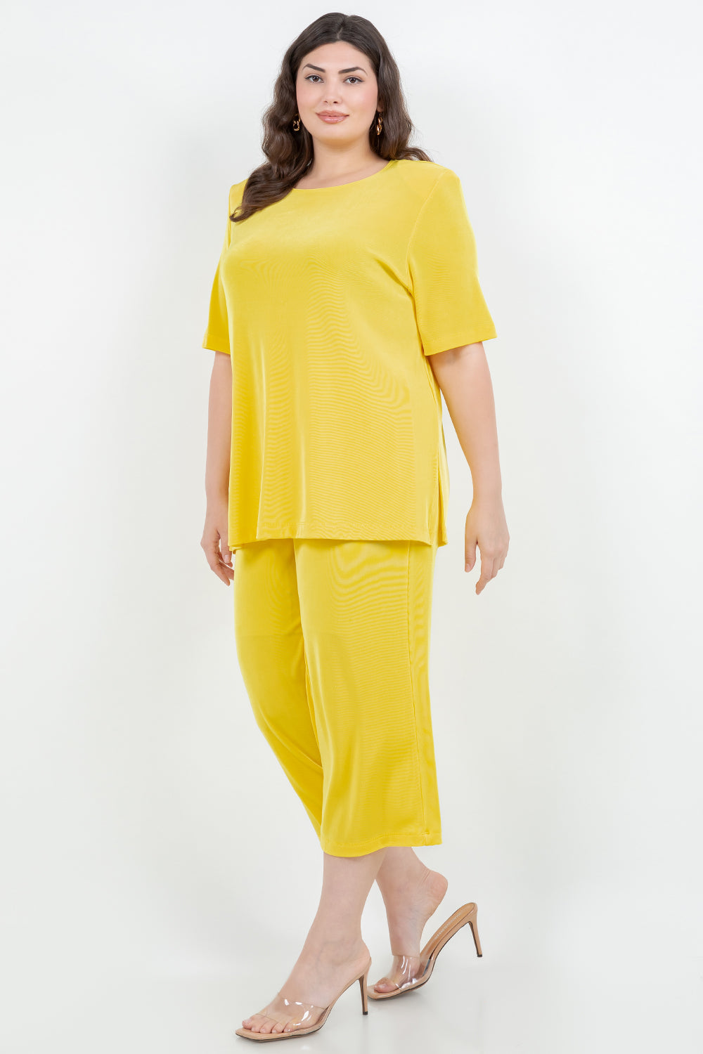 Woman wearing a yellow outfit on a white background