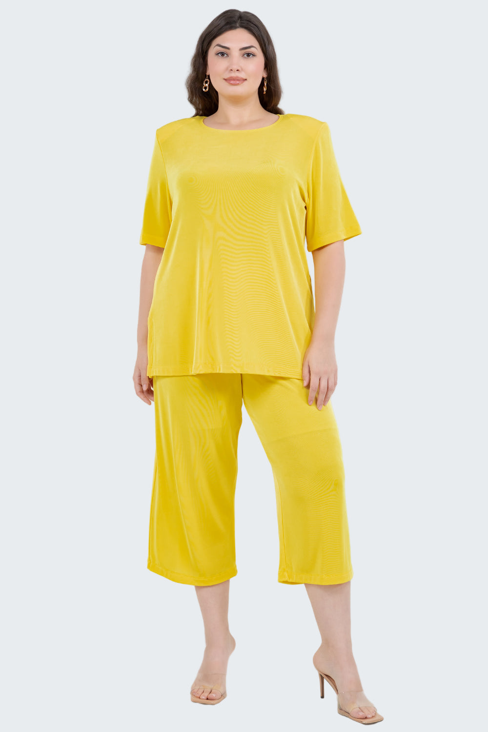 Woman wearing a yellow outfit on a white background