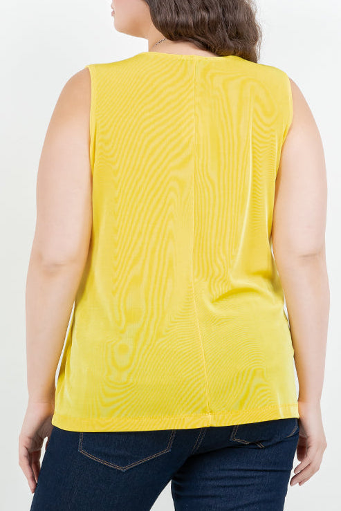 Person wearing a yellow sleeveless top with a subtle pattern on a white background