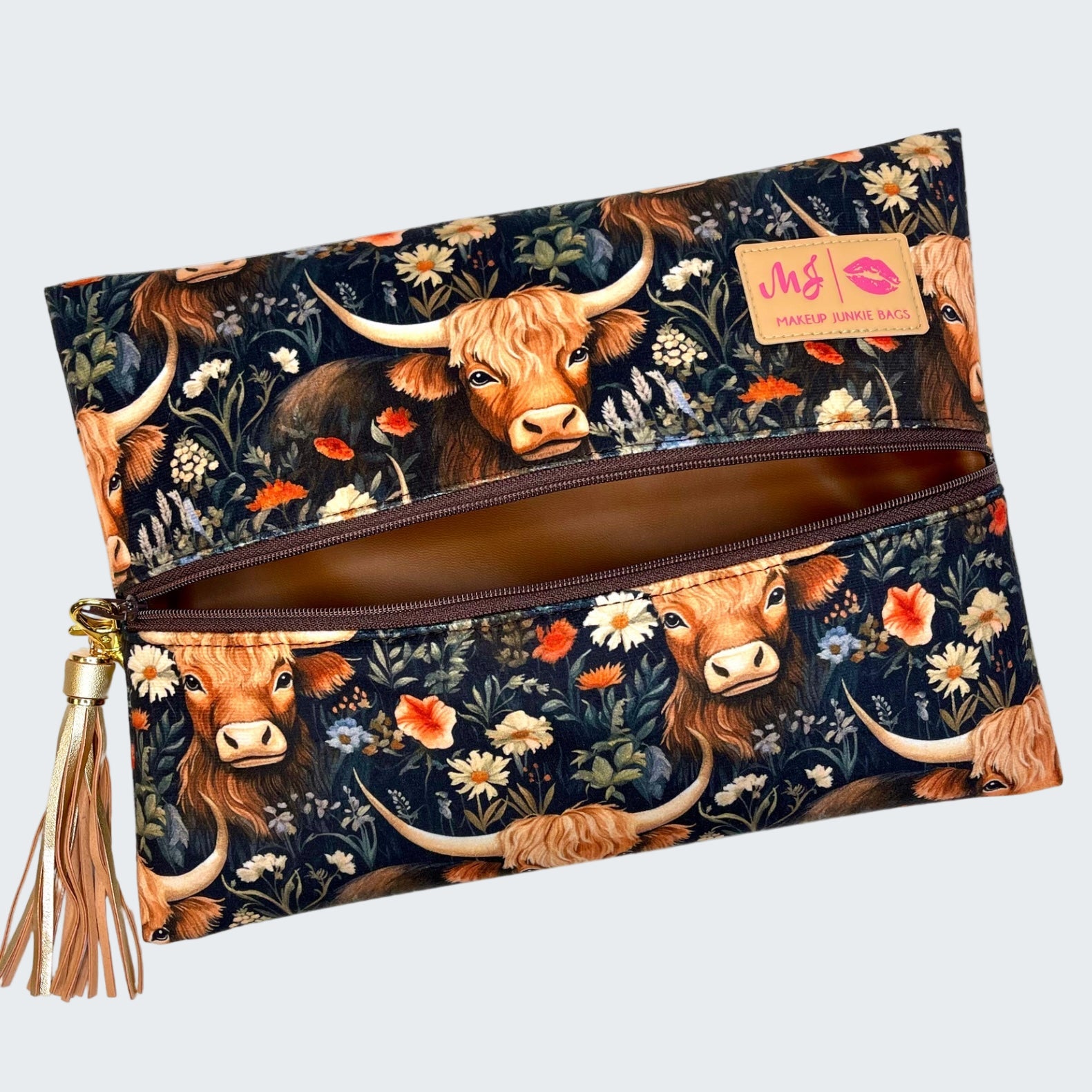 Clutch bag with longhorn cow and floral design on a white background