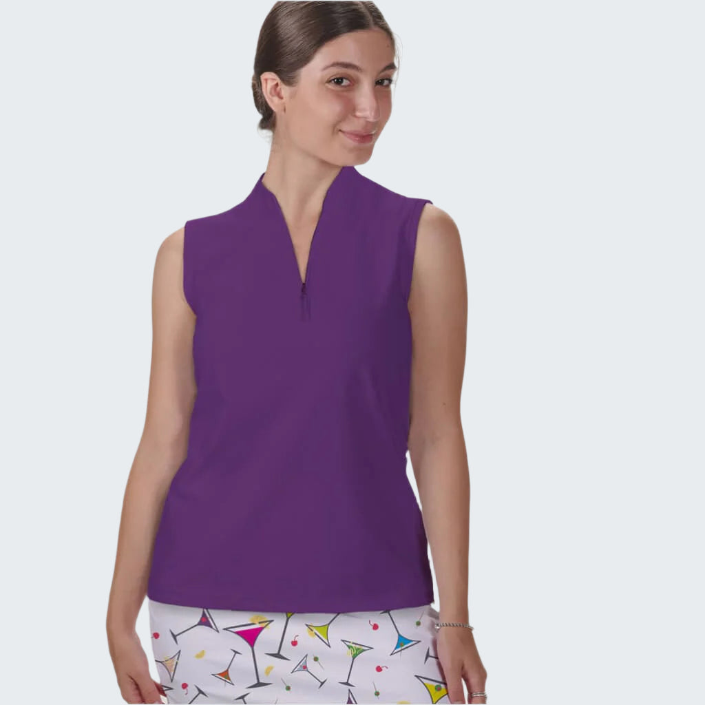 Woman wearing a purple sleeveless top with a white skirt featuring colorful patterns on a plain background