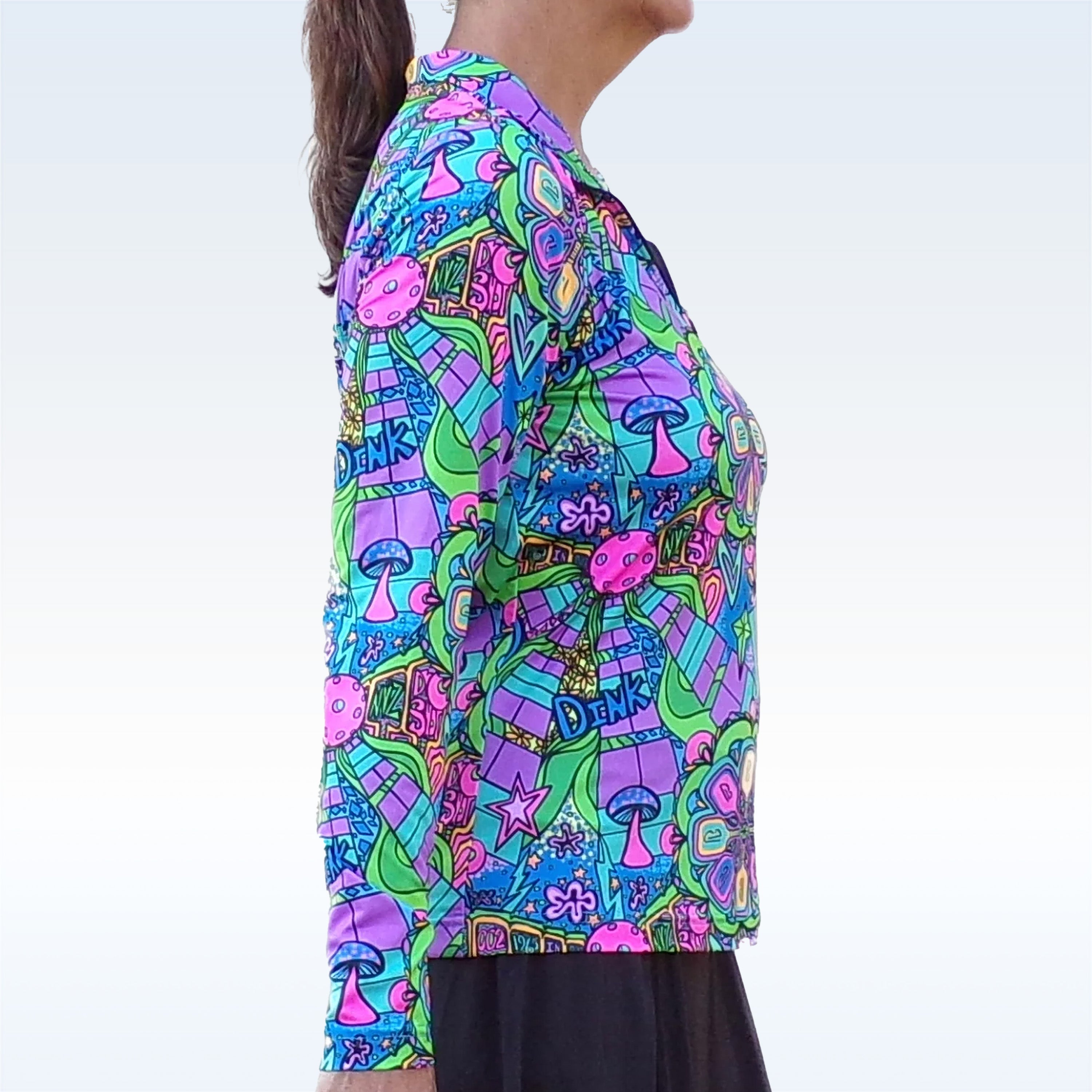 Person wearing a colorful psychedelic patterned shirt on a white background
