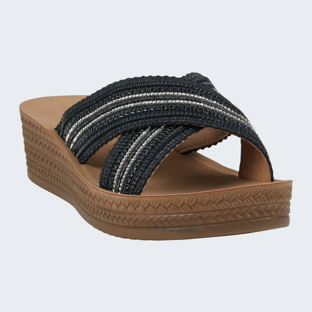 Black woven sandal with brown sole on a white background
