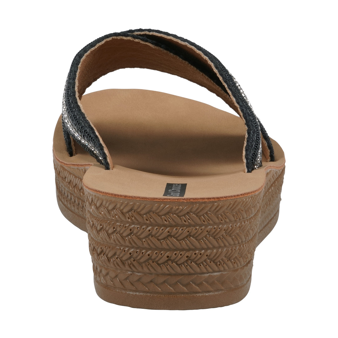 Brown sandal with textured sole and black strap on a white background