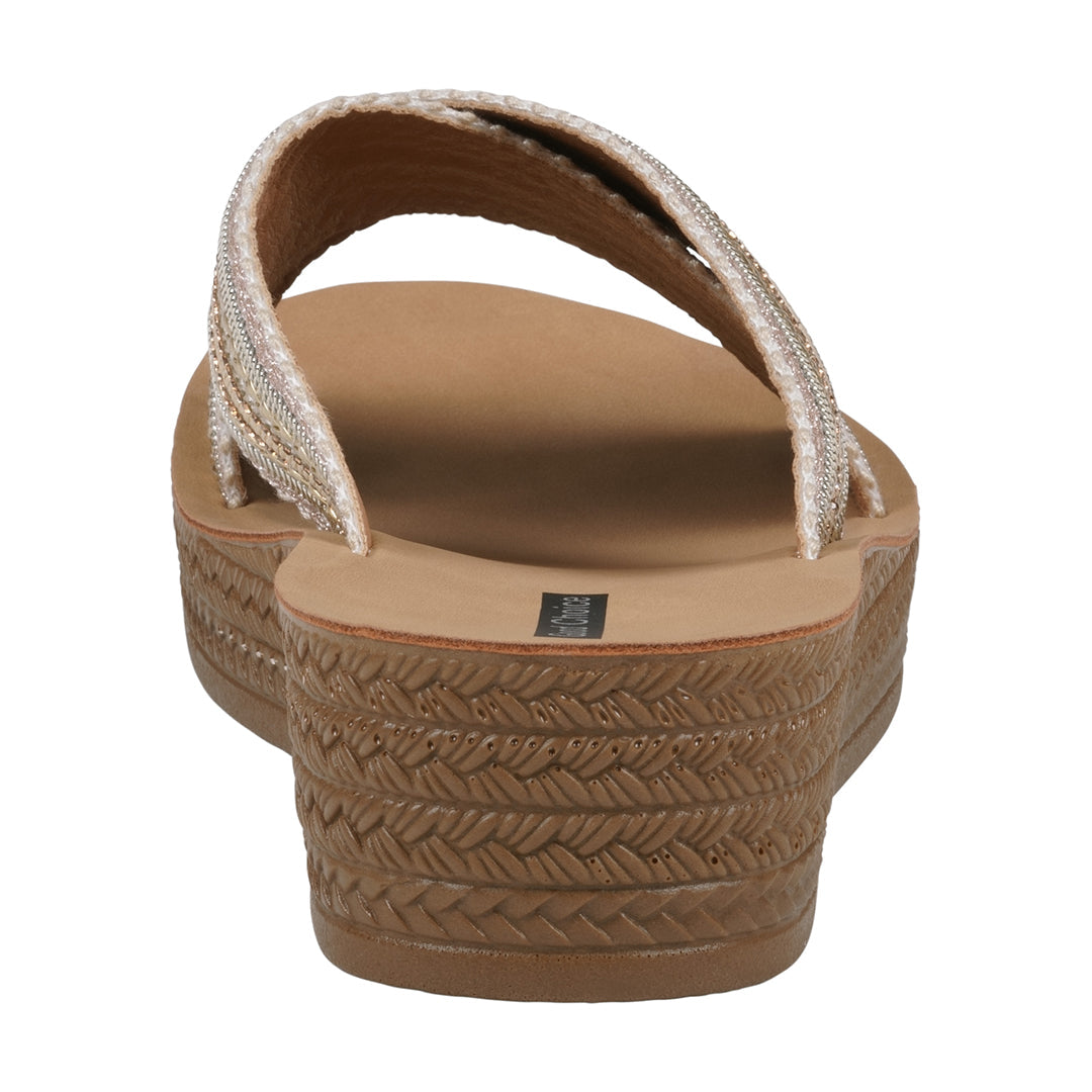 Brown sandal with textured sole on a white background