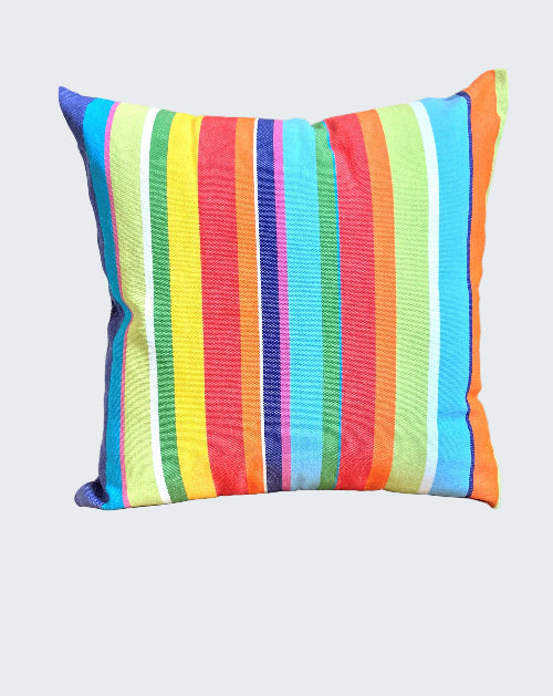 Colorful striped pillow on a wooden stool against a neutral wall