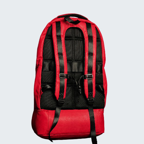Red backpack with black straps on a red background