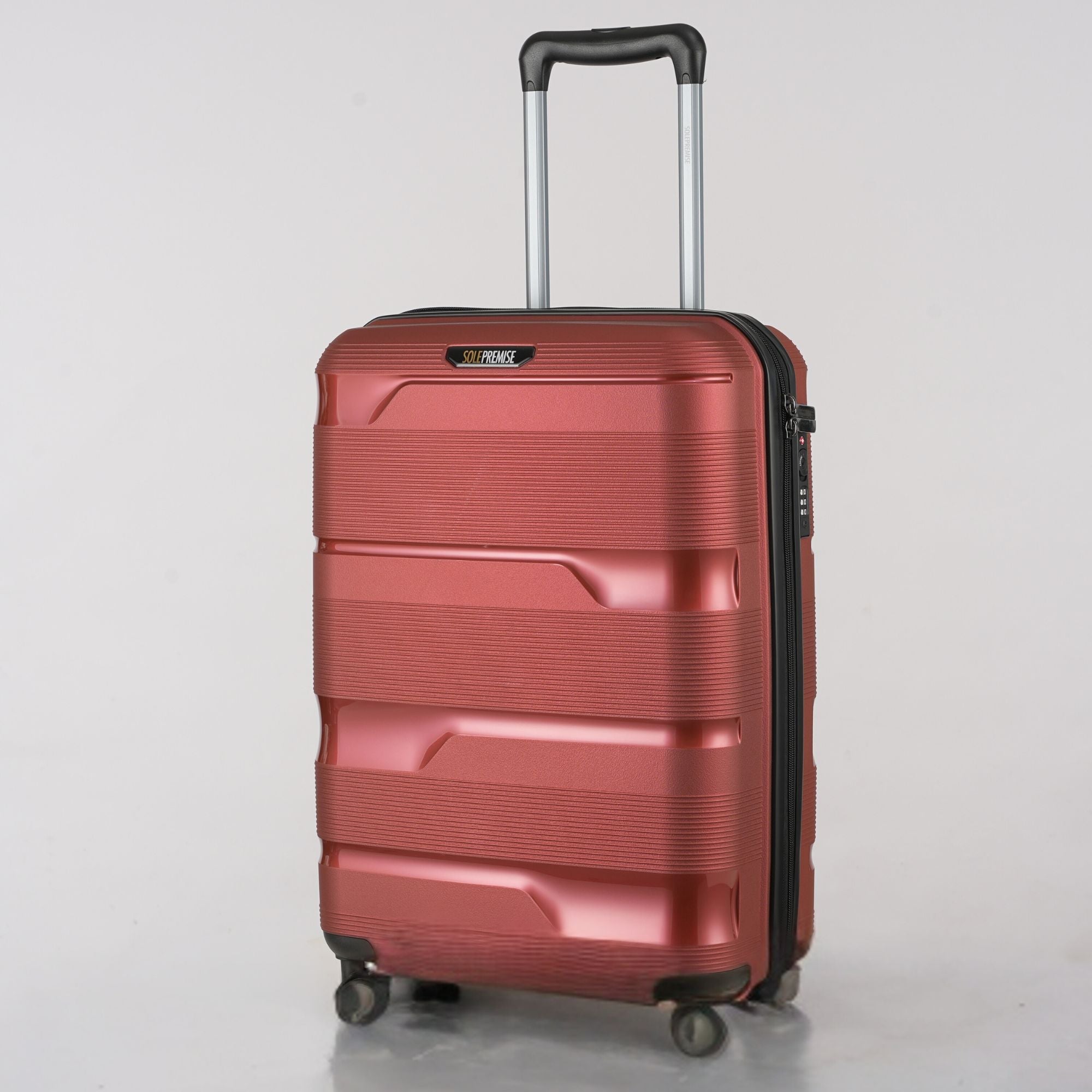 Red suitcase with a black handle on a light gray background