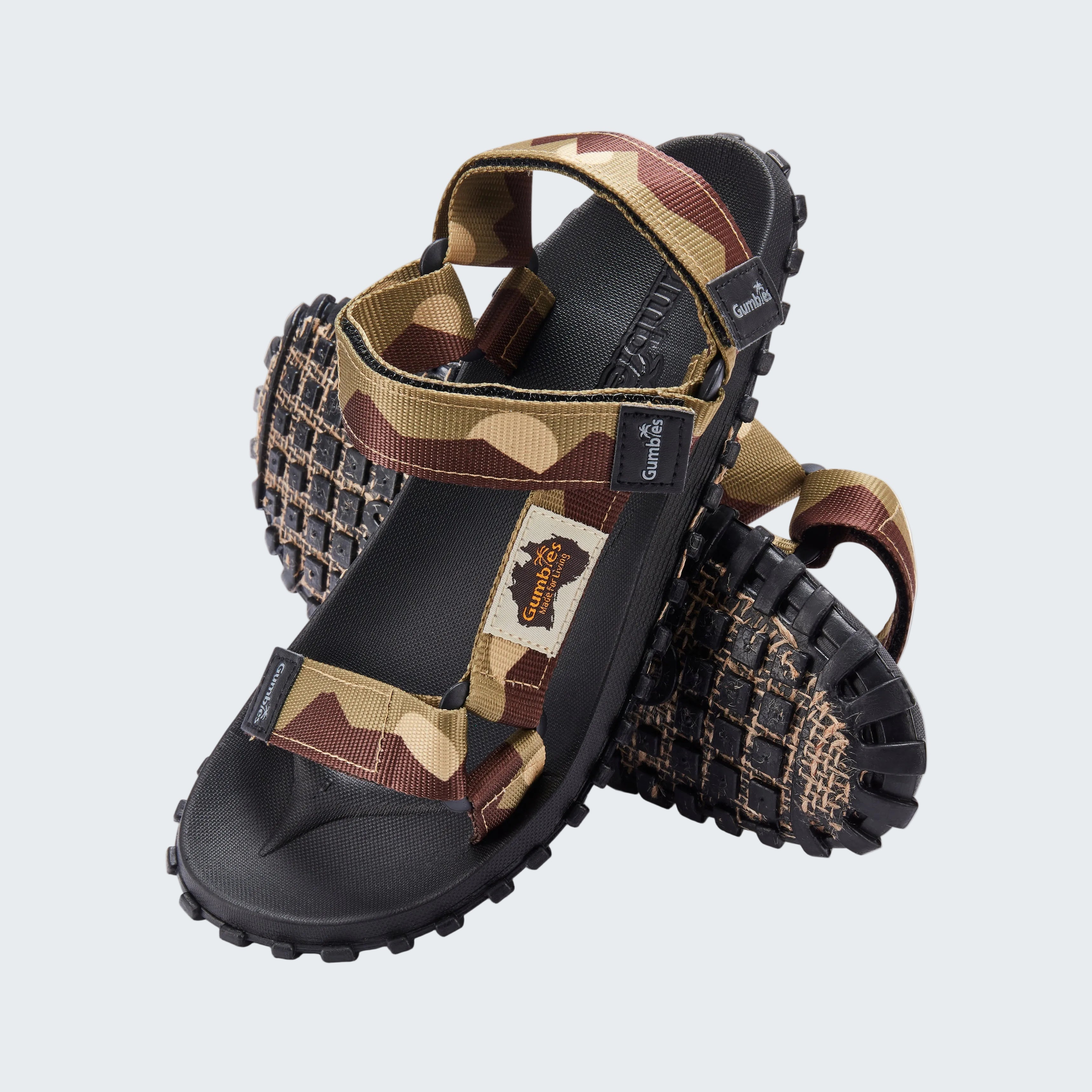 Camouflage-patterned sandal with black sole on a white background