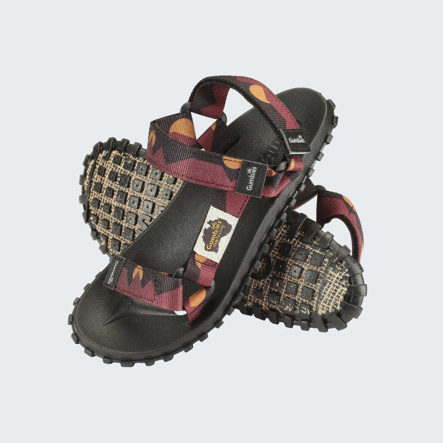 Pair of sandals with patterned straps on a white background