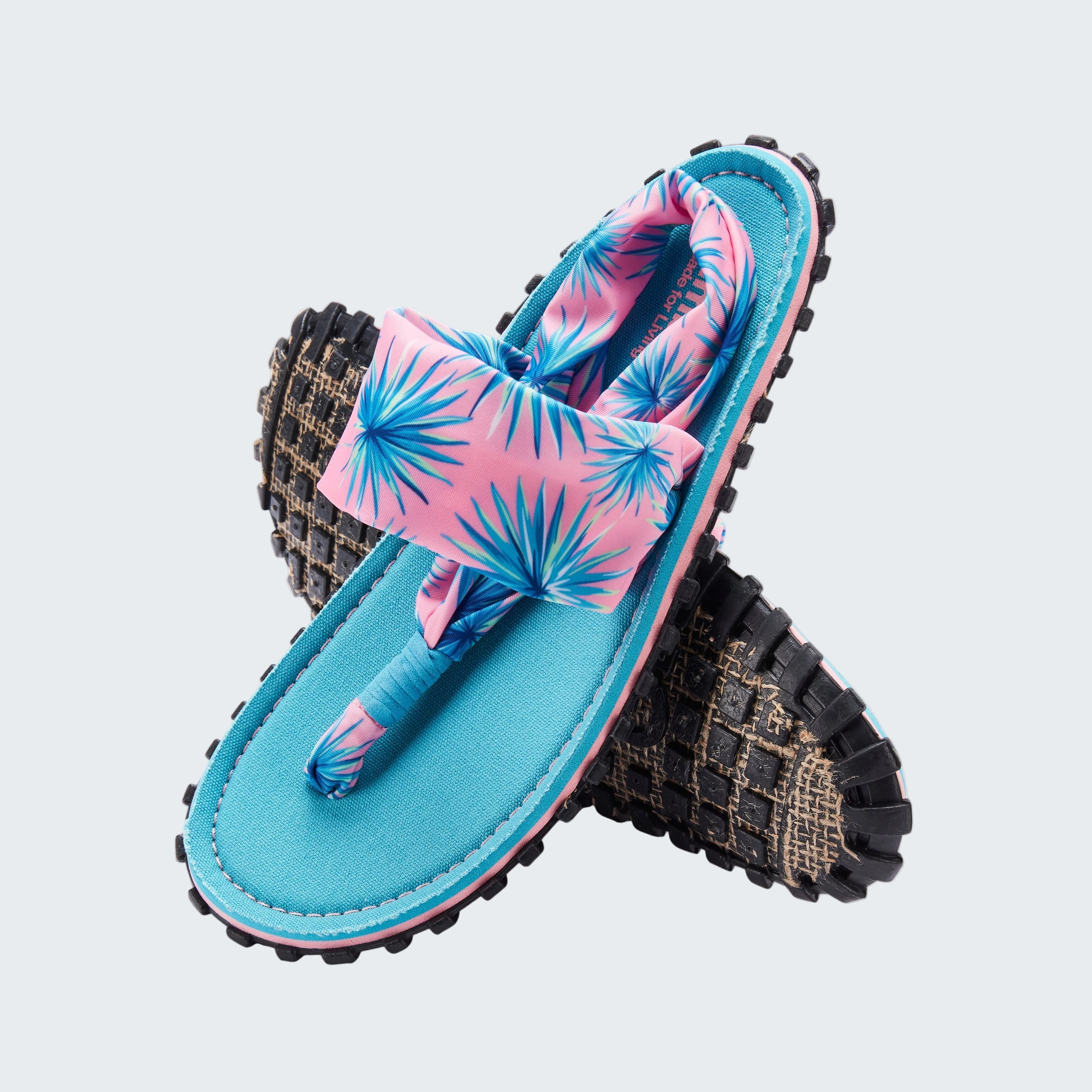 Pair of sandals with pink and blue floral design on a white background