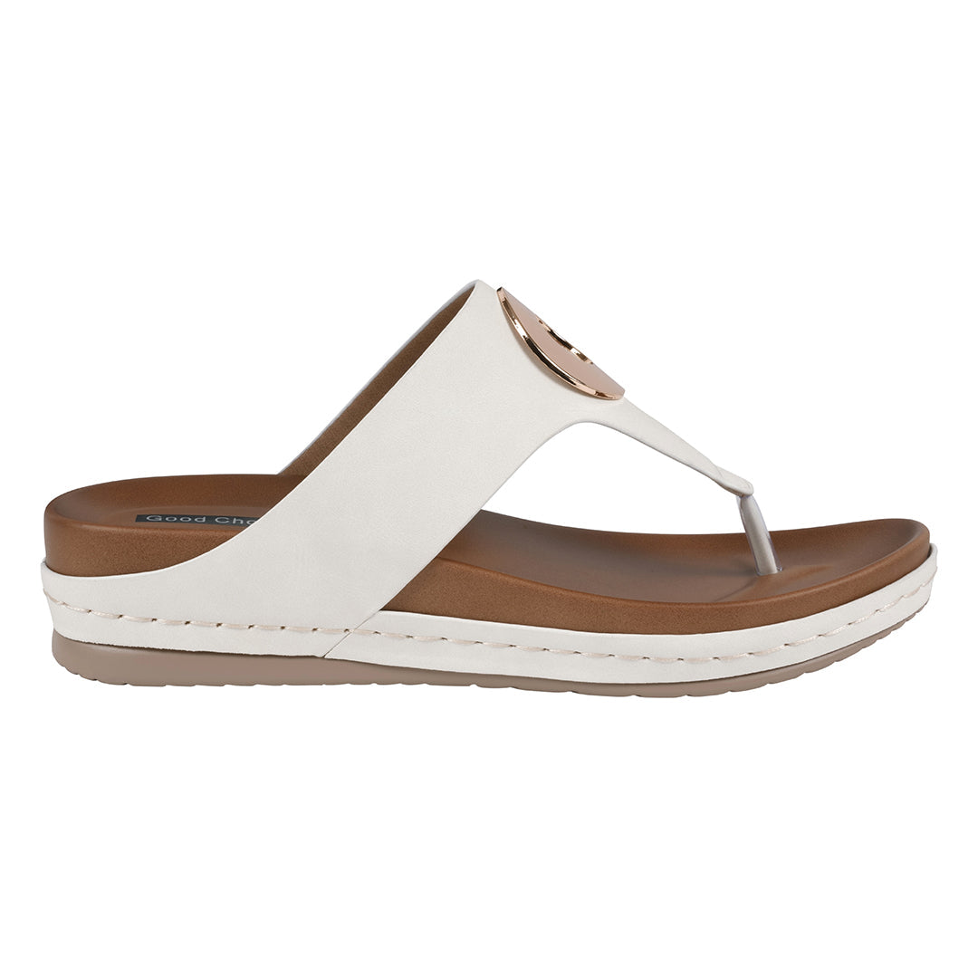 White sandal with brown sole on a white background