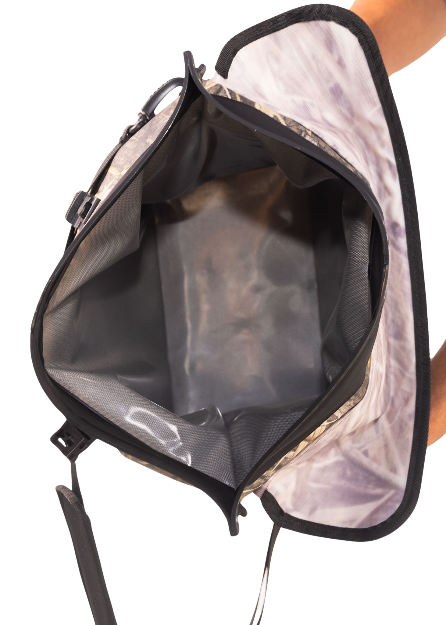 Backpack with reflective interior lining held by a person