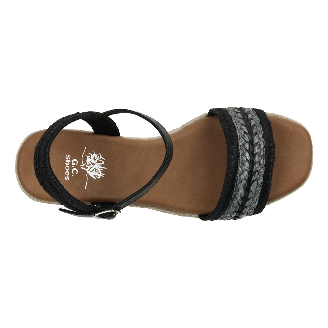Brown sandal with black and gray straps on a white background