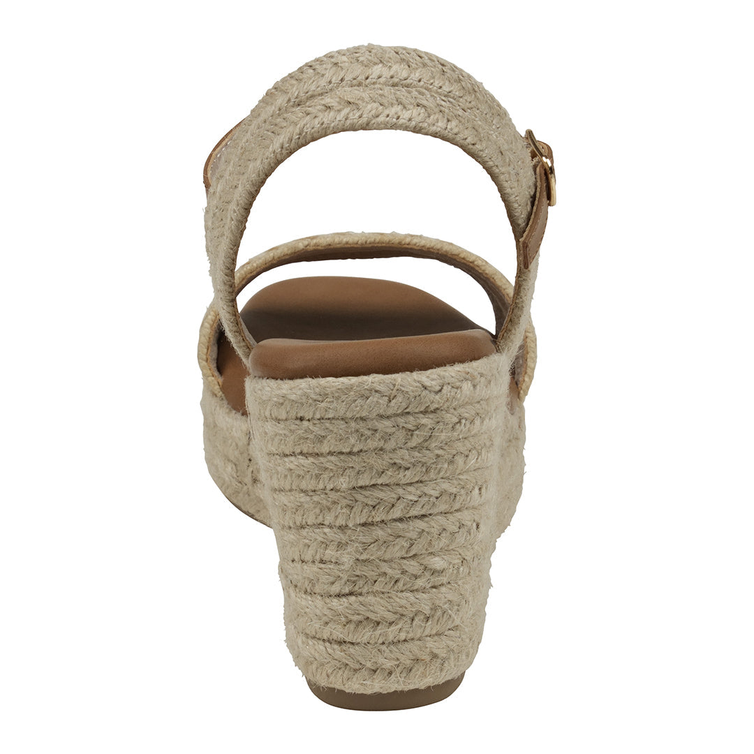 Beige wedge sandal with braided design on a white background