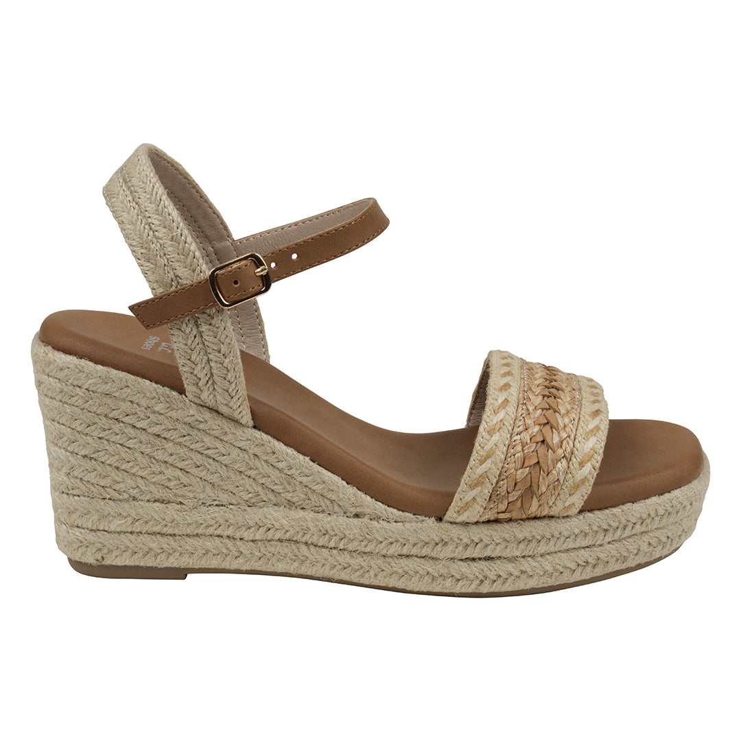 Beige wedge sandal with brown strap and sole on a white background