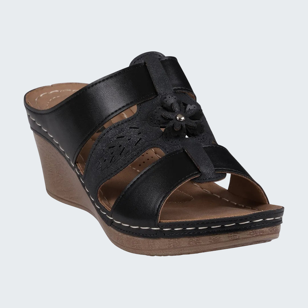 Black wedge sandal with wooden sole on a white background