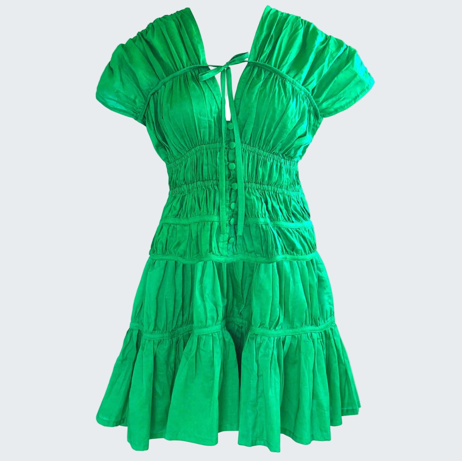 Green dress with ruffled layers on a white background