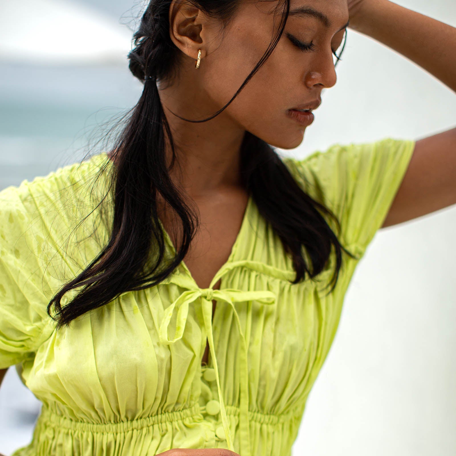 Woman wearing a bright yellow dress with a blurred background