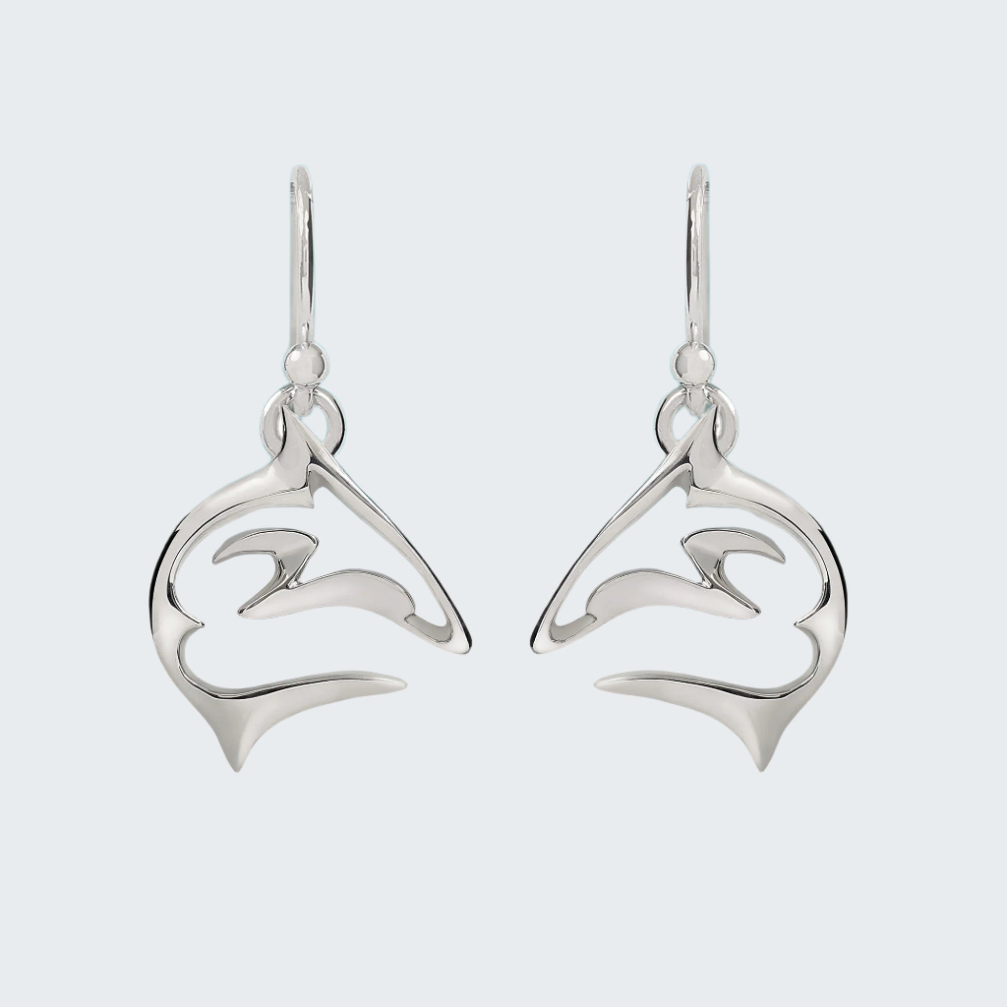 Pair of silver dolphin earrings on a light gray background