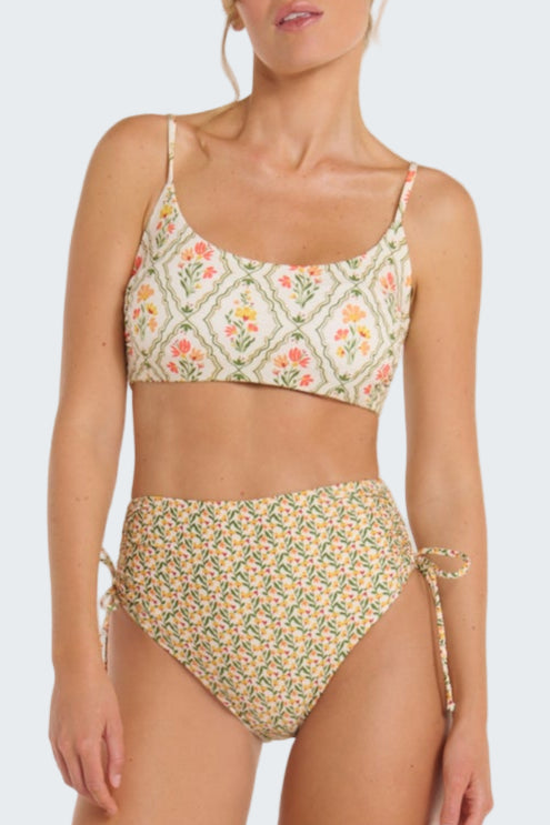 Woman wearing a floral bikini set on a white background