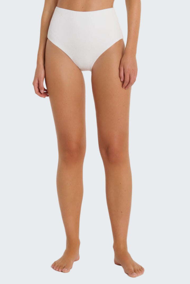 Person wearing white high-waisted bikini bottoms on a plain background
