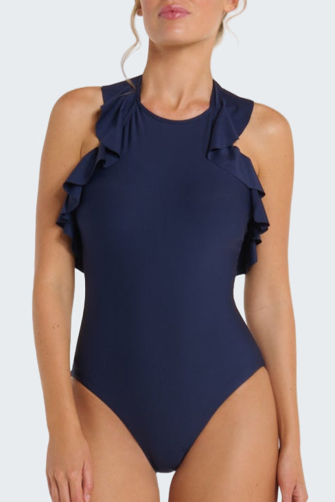 Navy blue one-piece swimsuit with ruffle details on a beige background