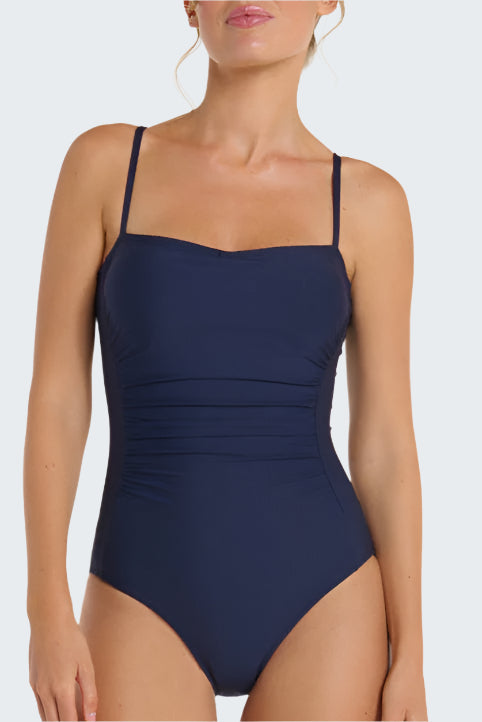 Navy blue one-piece swimsuit worn by a model on a white background