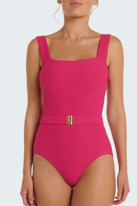 Pink swimsuit with a gold belt on a white background