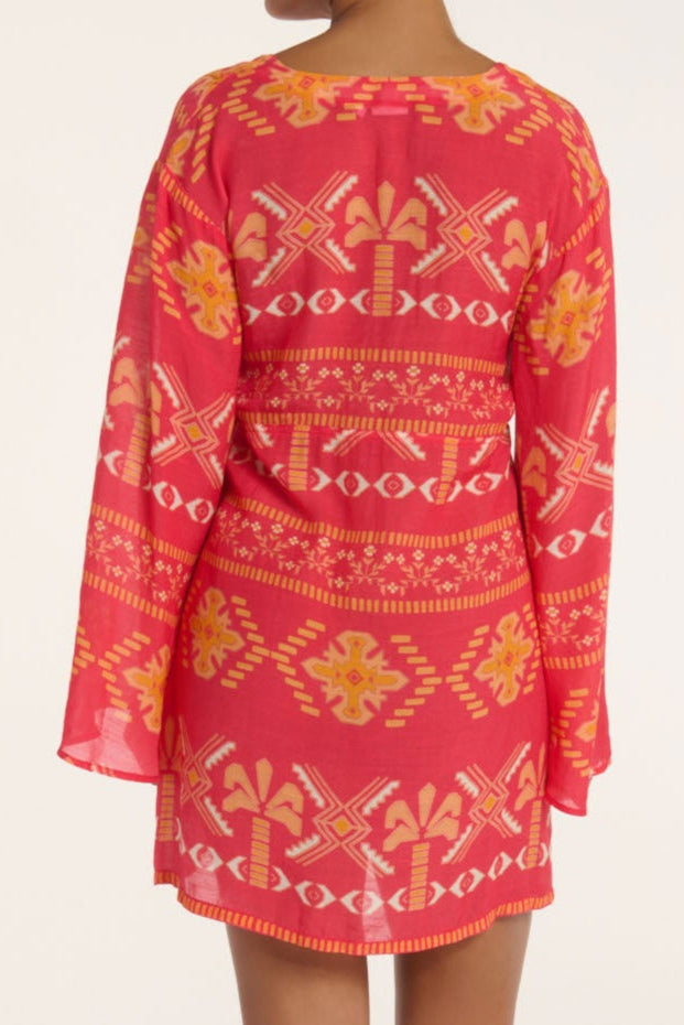 Pink dress with yellow and white geometric pattern on a plain background