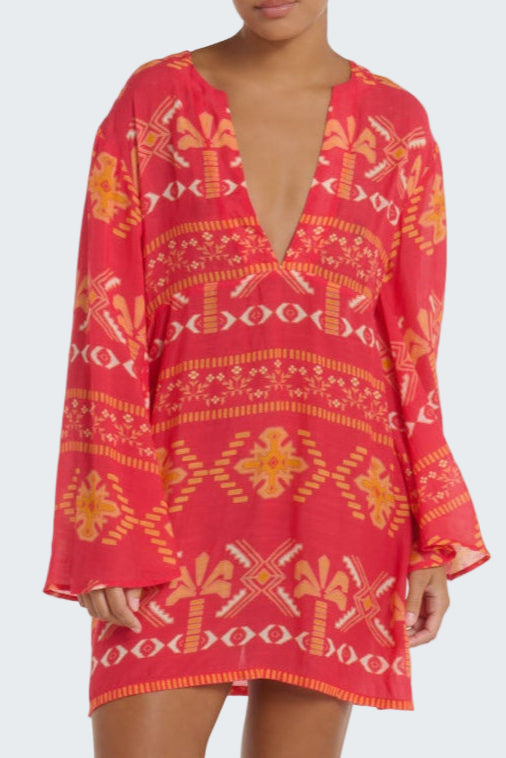 Red patterned dress with long sleeves on a plain background