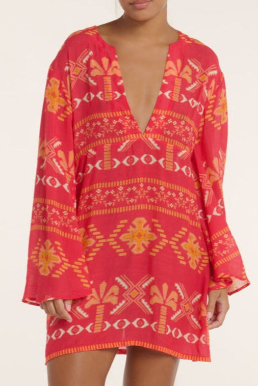 Red patterned dress with long sleeves on a plain background
